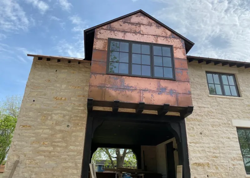 Copper metal panel facade on a stone building for Skylight Installation in Lemont