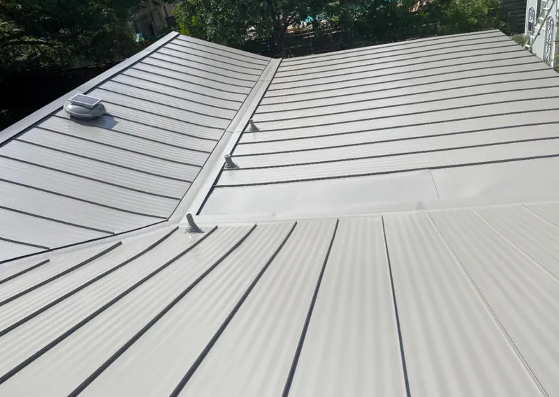 Solar attic fan installed on a metal roof for Roof Ventilation in Lemont